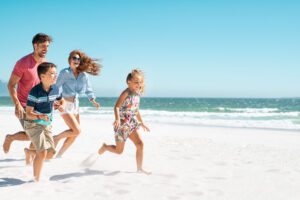 A family enjoying a beach day, one of the best things to do on Anna Maria Island.