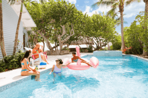 A group of women in the pool at their vacation rental during a Florida bachelorette party.
